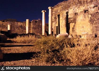 Light and ruins at night in Old Bosra, Syria