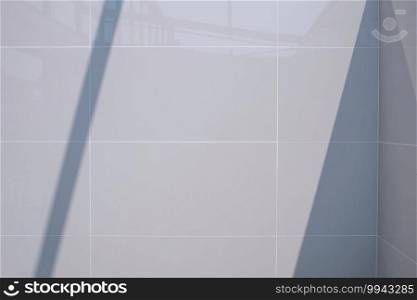 Light and shadow on surface of interior gray tile bathroom wall structure of modern house in construction site