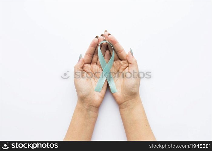 light blue ribbon crop hands. High resolution photo. light blue ribbon crop hands. High quality photo