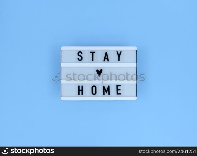 Light box with Stay home quote on blue background.. Light box with Stay home quote on a blue background.