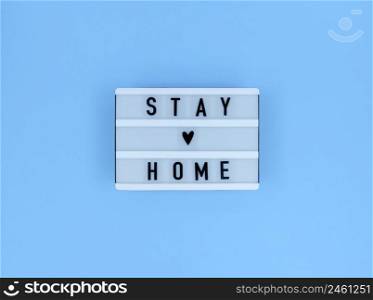 Light box with Stay home quote on blue background.. Light box with Stay home quote on a blue background.