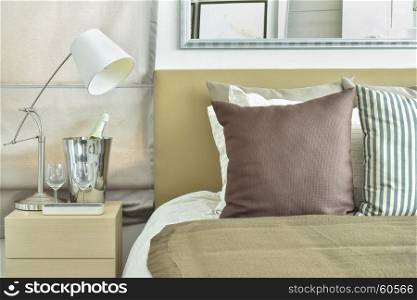 Light brown color scheme bedding with light brown headboard and table lamp