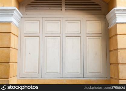 Light brown wooden door in the building. Old wooden doors with classic style building.