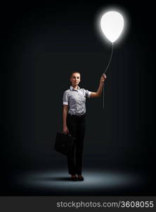 Light bulb and a business person as symbols of creativity in business