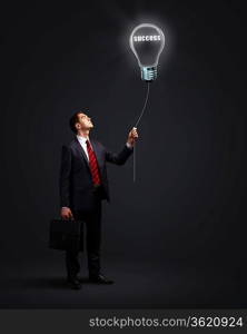 Light bulb and a business person as symbols of creativity in business