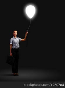 Light bulb and a business person as symbols of creativity in business