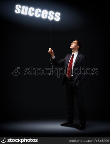 Light bulb and a business person as symbols of creativity in business