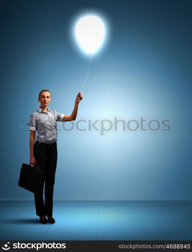 Light bulb and a business person as symbols of creativity in business