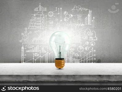 Light bulb and drawing business strategy at background. Ideas for your business