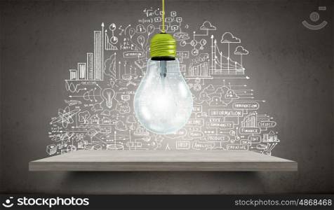 Light bulb and drawing business strategy at background. Ideas for your business