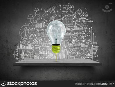 Light bulb and drawing business strategy at background. Ideas for your business