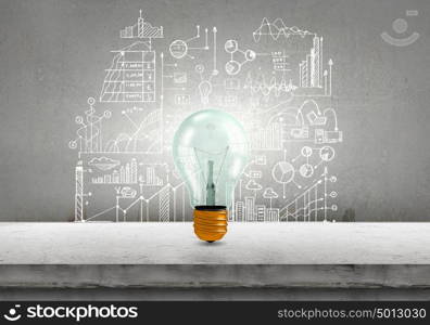 Light bulb and drawing business strategy at background. Ideas for your business