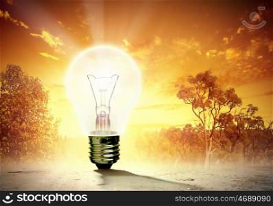 Light bulb and nature. Image of light bulb against nature background. Ecological concept