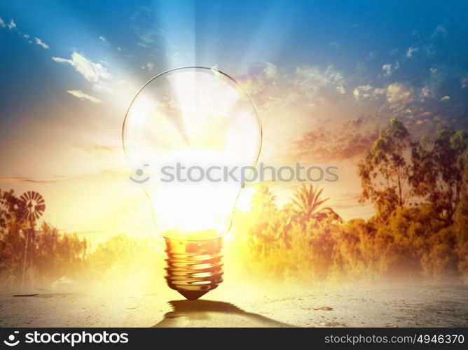 Light bulb and nature. Image of light bulb against nature background. Ecological concept