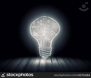 Light bulb. Background image with glowing light bulb on wooden surface