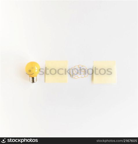 light bulb brain with two adhesive notes white background