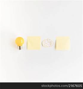 light bulb brain with two adhesive notes white background