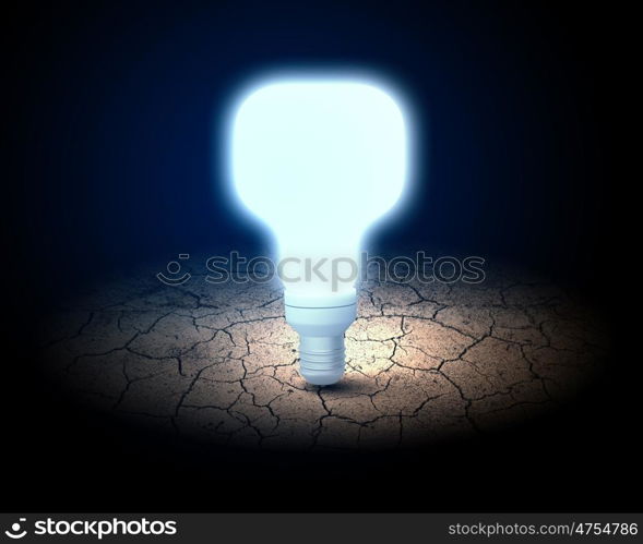 Light bulb. Close up of glowing light bulb in desert