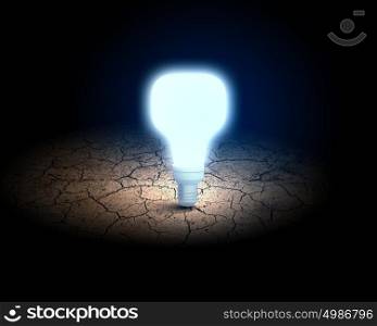 Light bulb. Close up of glowing light bulb in desert