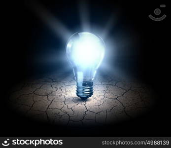 Light bulb. Close up of glowing light bulb in desert