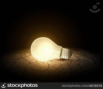 Light bulb. Conceptual image of light bulb on desert surface