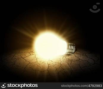 Light bulb. Conceptual image of light bulb on desert surface