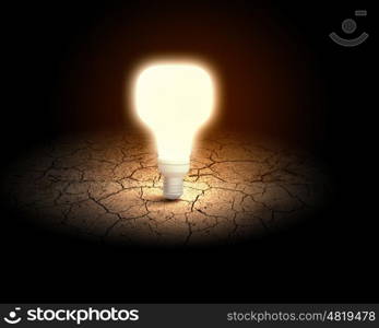 Light bulb. Conceptual image of light bulb on desert surface