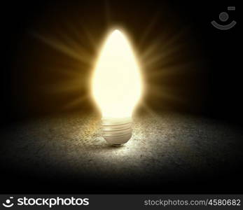 Light bulb. Conceptual image with light bulb and cement surface