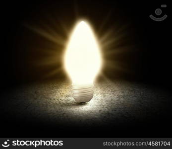 Light bulb. Conceptual image with light bulb and cement surface