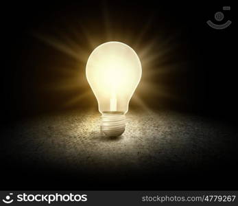 Light bulb. Conceptual image with light bulb and cement surface