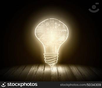 Light bulb. Conceptual image with light bulb and wooden surface