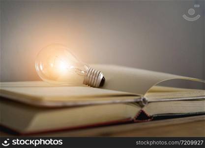 Light bulb glowing on empty book.smart thinking and education concept.