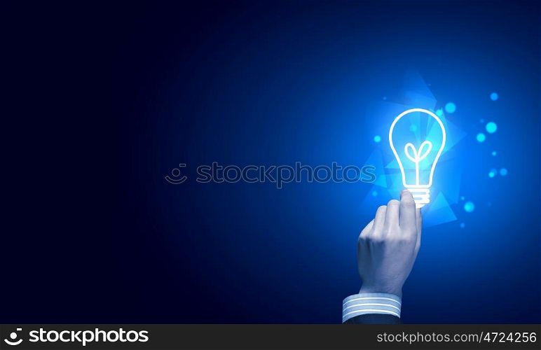 Light bulb in hand. Close up of human hand holding light bulb