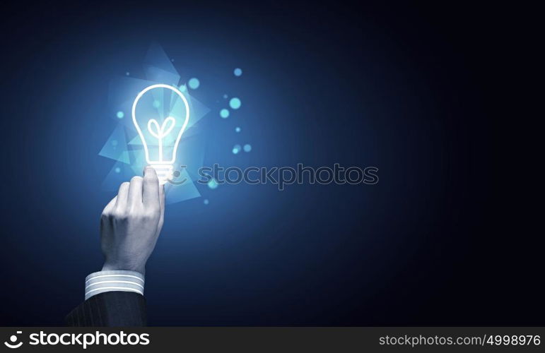 Light bulb in hand. Close up of human hand holding light bulb