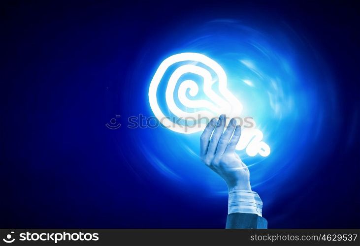 Light bulb in hand. Close up of human hand holding light bulb in palm