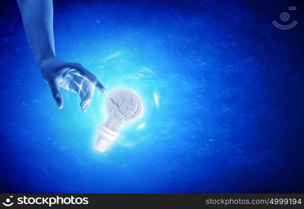 Light bulb in hand. Close up of human hand touching with finger light bulb