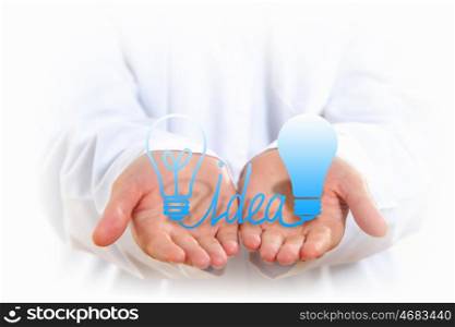 Light bulb in hand. Close up of human hands with light bulb figure