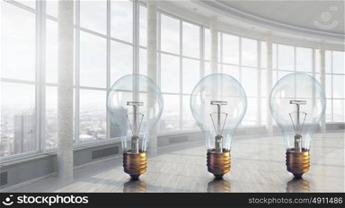 Light bulb in modern office. Big glass light bulb in bright modern interior