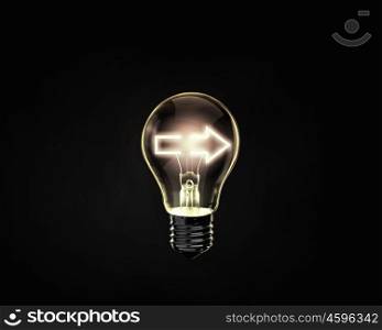 Light bulb. Light bulb with arrow inside on dark background