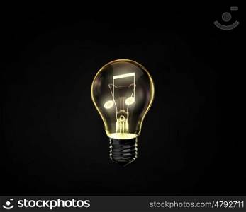 Light bulb. Light bulb with music note inside on dark background