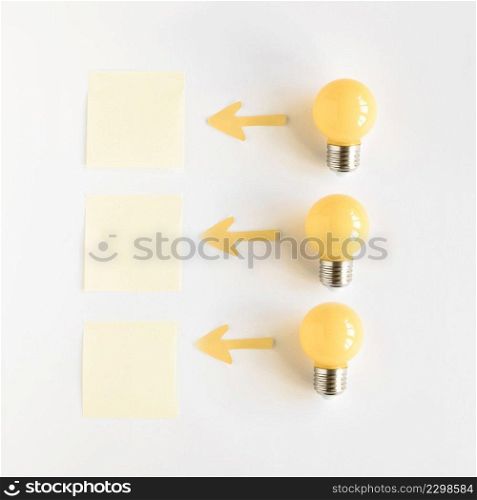 light bulb near arrow symbols showing direction towards adhesive notes