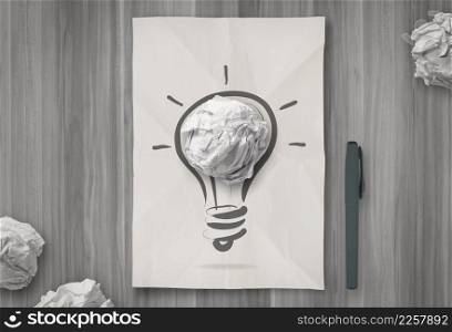  light bulb on crumpled paper as creative concept