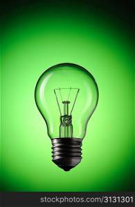 Light Bulb over green background