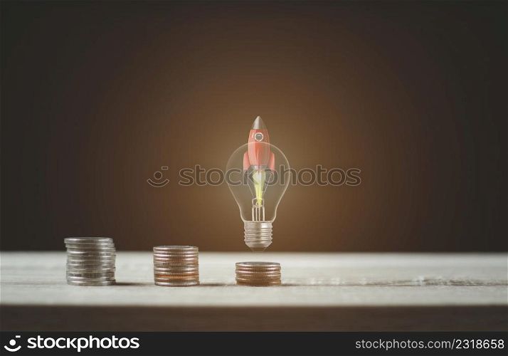Light bulb rocket with coin ladder for financial plans or business ideas.
