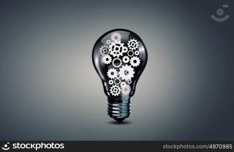 Light bulb with gears. Conceptual image with light bulb filled with gears