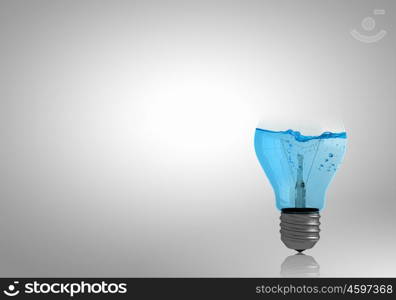 Light bulb with water. Energy and ecology concept with light bulb with water inside