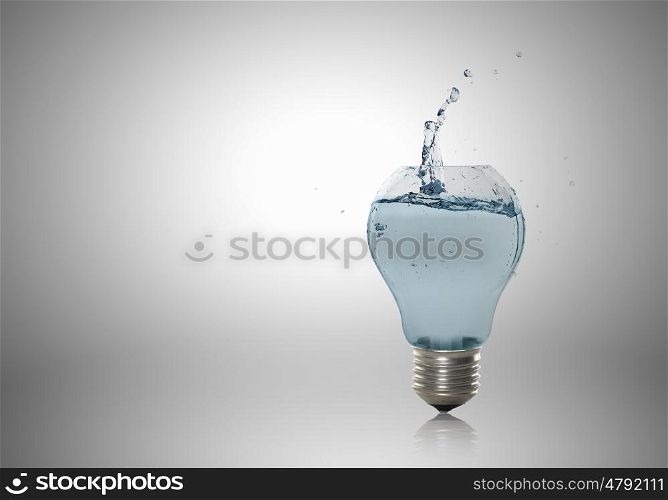 Light bulb with water. Energy and ecology concept with light bulb with water inside