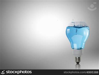 Light bulb with water. Energy and ecology concept with light bulb with water inside