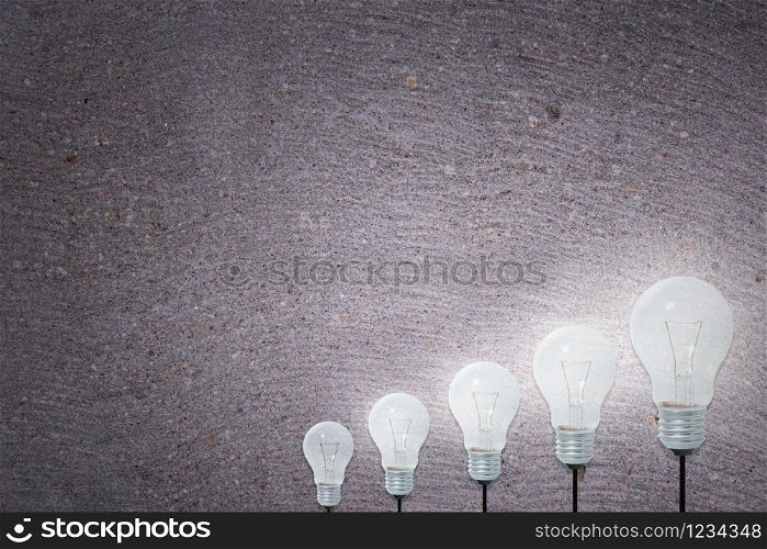 Light Bulbs Concept gray cement background