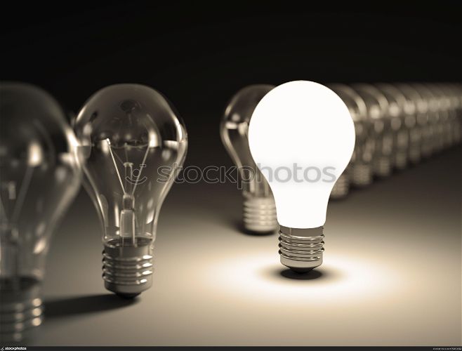 Light bulbs in a row with glowing one on black background.